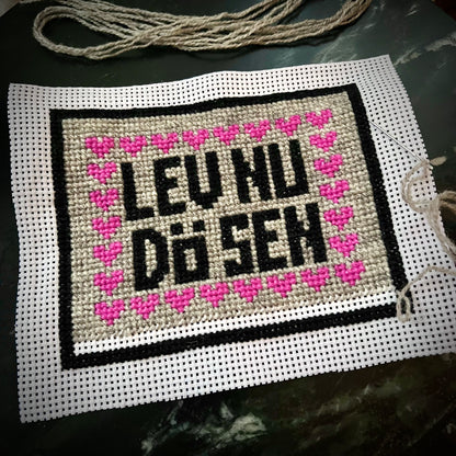 Broderikit med ullgarn med texten lev nu dö den